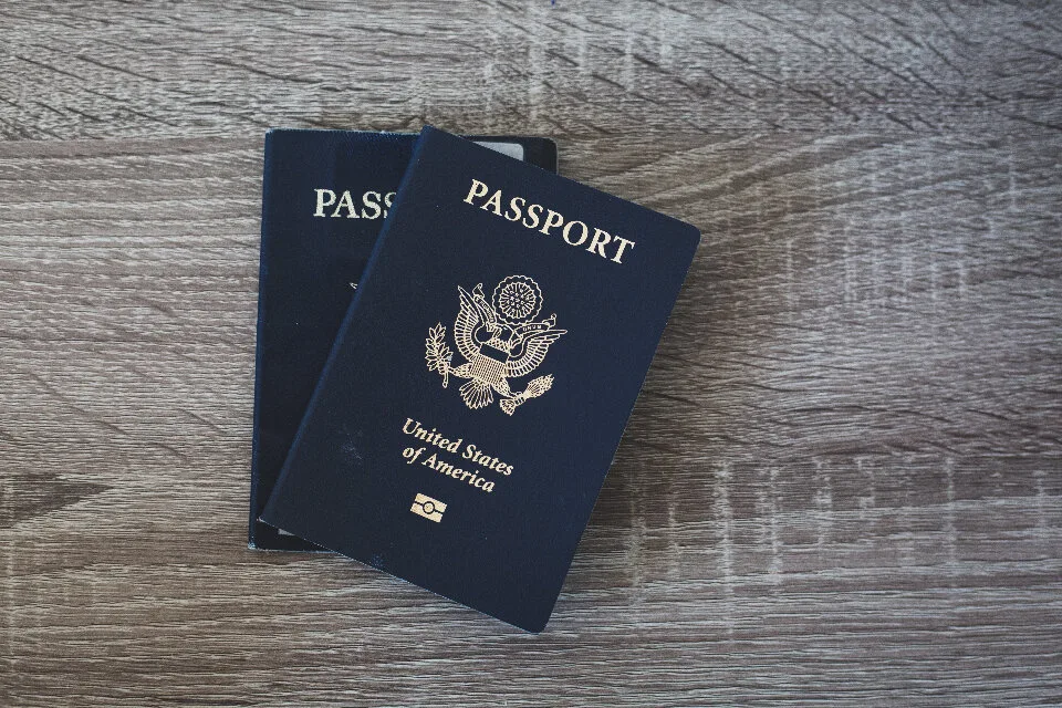 Passport, boarding pass and travel documents on a desk